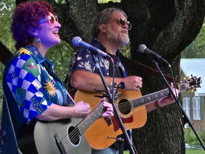 Kristi and Steven playing beneath a large tree